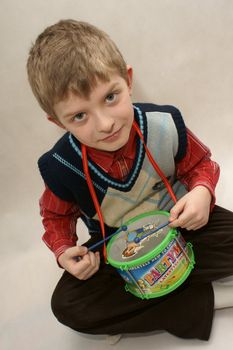 young boy with drums in white background