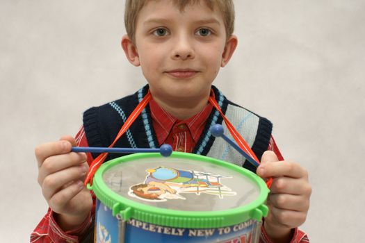 young boy with drums in white background