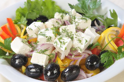 Close-up slices of cheese in a salad of feta cheese and diced vegetables