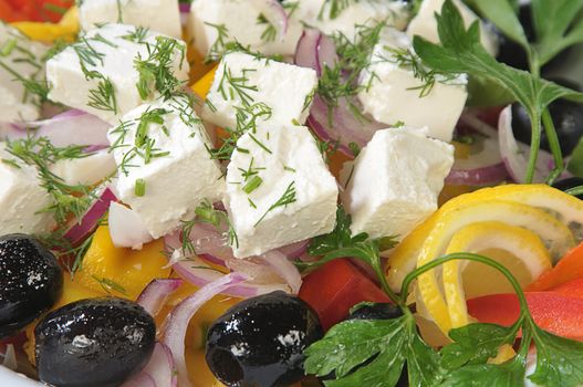 Close-up slices of cheese in a salad of feta cheese and diced vegetables