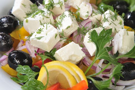 Close-up slices of cheese in a salad of feta cheese and diced vegetables