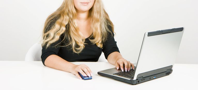 a young girl working on laptop in a bright room
