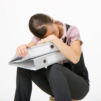 tired girl slept on the books on a white background
