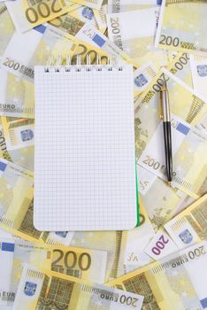 Writing-book with pen on banknotes 200 euros