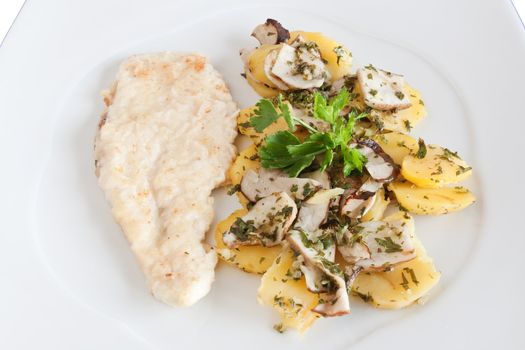 chicken escalope with baked potatoes and mushrooms isolated on white with clipping path