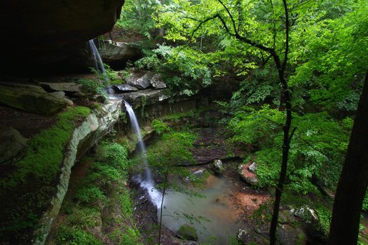 Waterfall flows into a deep canyon in the woodland of northern Alabama.