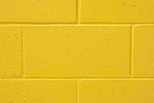 Background of a yellow painted cement wall with copy space