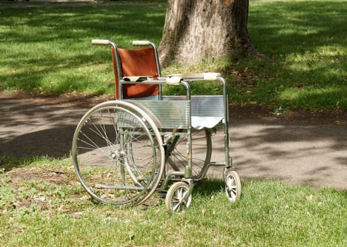 Old wheelchair abandoned in a park