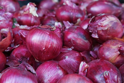 Pile of red onions at the farmers market