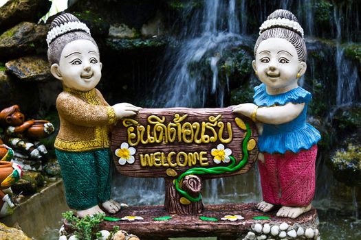 Thai woman holds the sign You're welcome