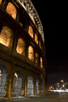 part of the famous coliseum in Rome at night