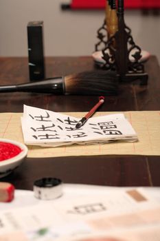 Traditional asian calligraphy set on wooden table