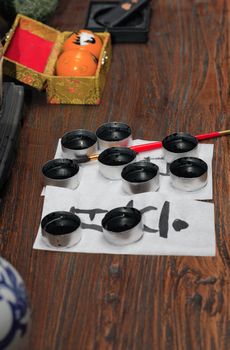 Traditional asian calligraphy set on wooden table