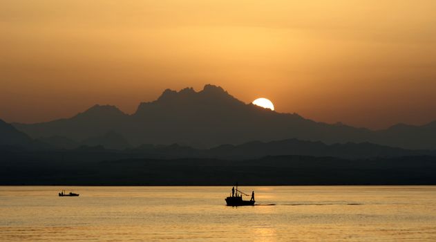 Egypt sunset sea boat sun mountains