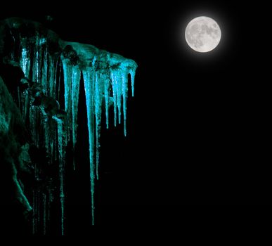 Icicles and the moon on black background