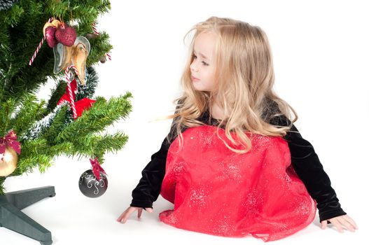 Beautiful baby girl dressed up for Christmas isolated in white