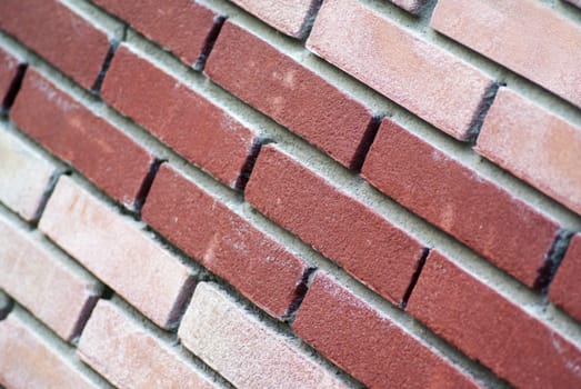 A two color brick wall, in diagonal lines.