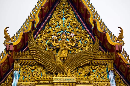 The elongated and elaborately carved apex of the gable in Temple Thailand