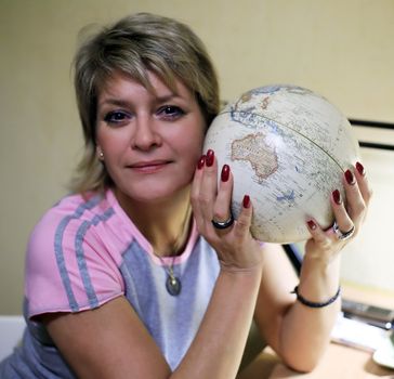 The adult woman with globe in hands