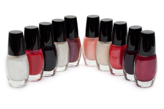 Group of nail polishes. Close-up. Over white.