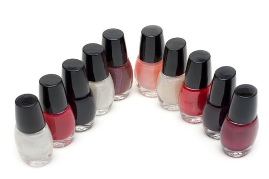 Group of nail polishes. Close-up. Over white.