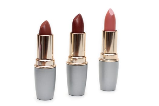 Three feminine lipsticks, tubeses insulated on white background