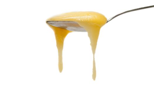 Iron spoon flowing down honey, drop, insulated on white background