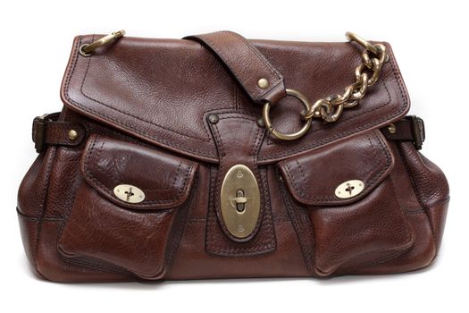 Beautiful brown leather feminine bag with golden chain-handle and lock insulated on white background