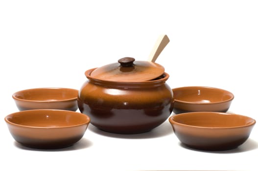 Ceramic ware and wooden spoon on a white background.