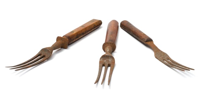 Three old rusty fork on a white background.