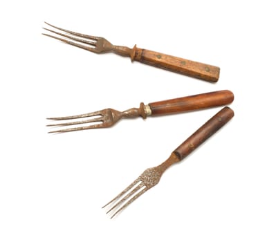 Three old rusty fork on a white background.