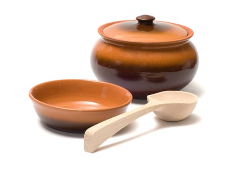 Ceramic ware and wooden spoon on a white background.