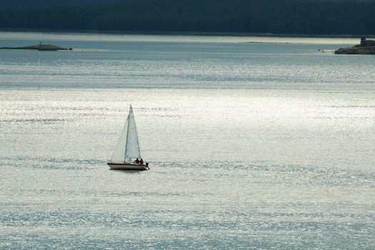 The small lonely yacht against the evening sea