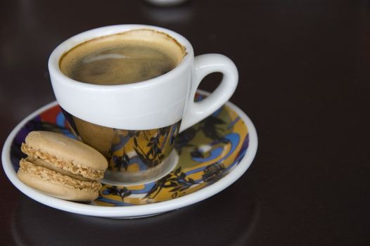 Cup of espresso 
coffee with little biscuit