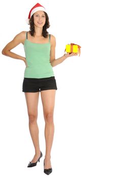 Very sexy young woman in hot pants standing with christmas present in her hand and santa hat. Isolated on white background.