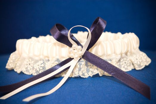 Wedding decor of a blue garter with robbon of lint and lace