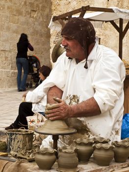 MDINA, MALTA - APR19 -  Potter using medieval tools in Mdina in Malta April 19, 2009