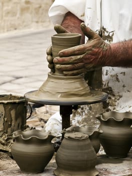 Detail of a pottery maker hands at work on clay pottery