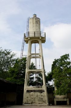 Old abandoned industrial water tower with reservoir tank in  factory