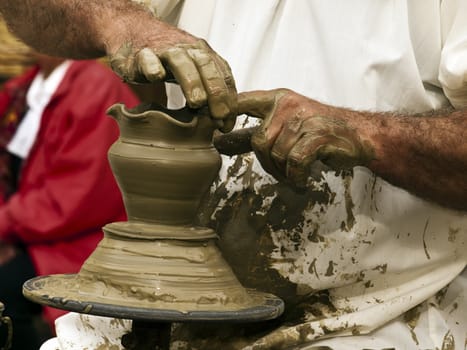 Detail of a pottery maker hands at work on clay pottery