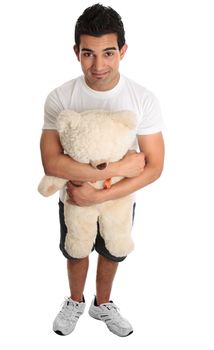 Young man holding hugging a teddy bear.  White background.