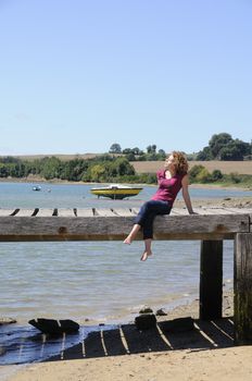 Beautiful young woman relaxing at the coast of Brittany, France