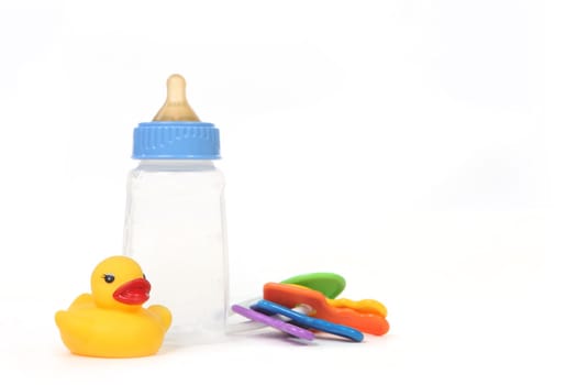 Infant Baby Bottle With Rubber Duckie on White Background
