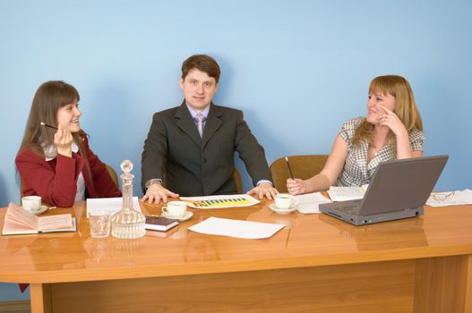 Business team sits at the big table