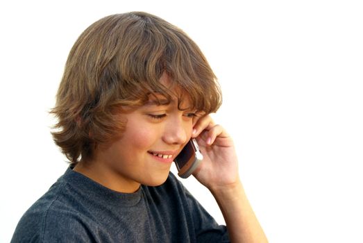 Smiling teenage boy talking on mobile phone isolated on white background.