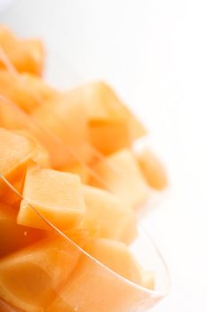 cantaloupe cut and in parfait glass light background