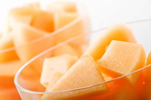 cantaloupe cut and in parfait glass light background