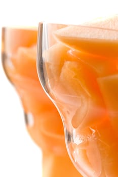 cantaloupe cut and in parfait glass light background