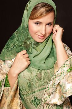 Young arab woman with veil close-up portrait on dark background