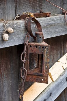 Rusty lamp on the old fence. Rural life close up.